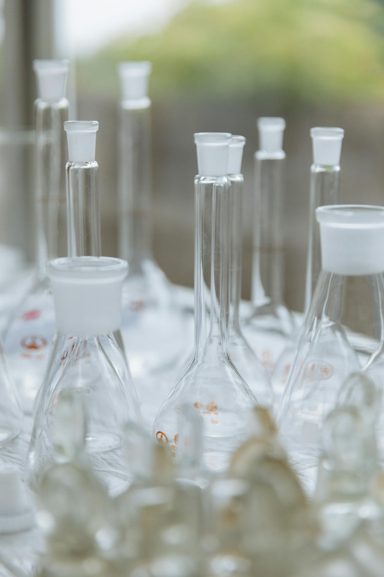 Empty laboratory glassware in soft light, representing the cosmetic chemistry and regulatory science behind methylisothiazolinone restrictions