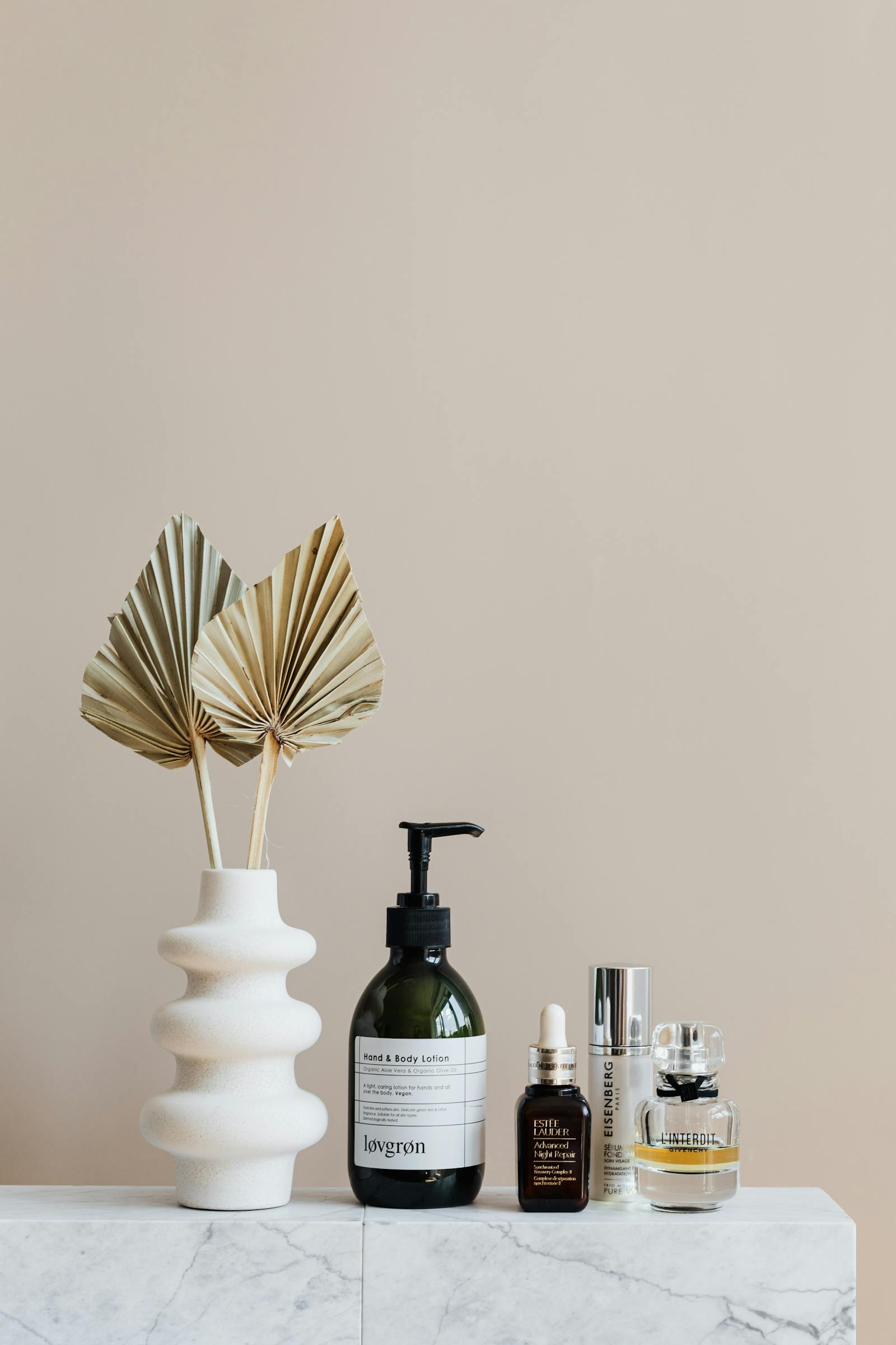 Skincare products on a marble bathroom shelf reformulated to comply with EU microplastic restrictions