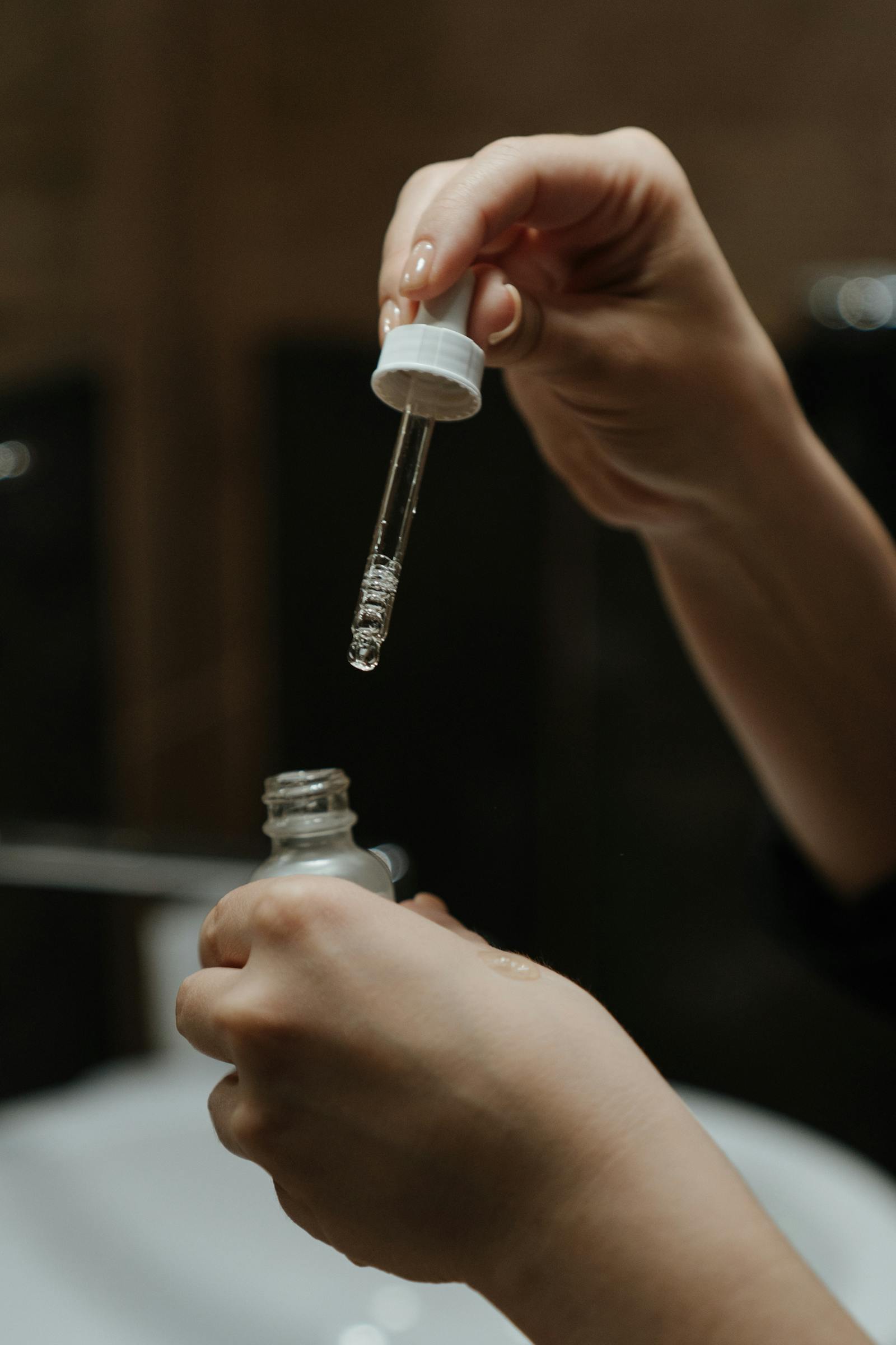 A white skincare bottle held against a soft neutral background, representing a typical niacinamide serum format