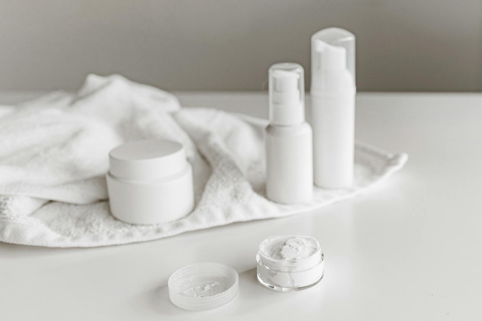 Minimalist arrangement of ceramide moisturisers and barrier-supportive skincare on a clean white surface